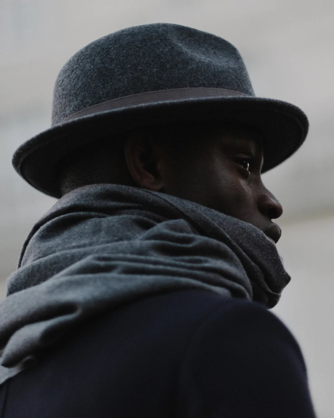 a man wearing a gray hat and scarf