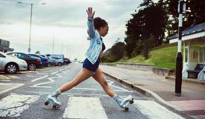 a woman riding roller skates across a street