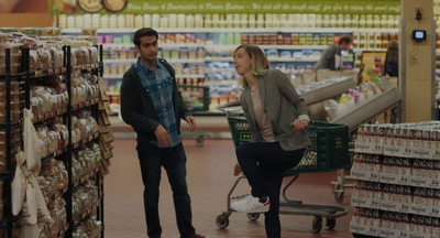 a man and a woman shopping in a grocery store