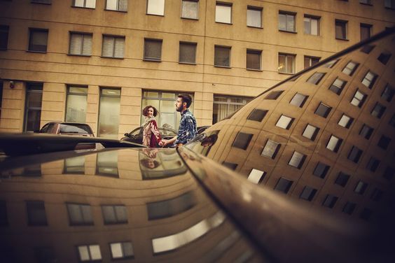 a man and a woman standing in front of a building