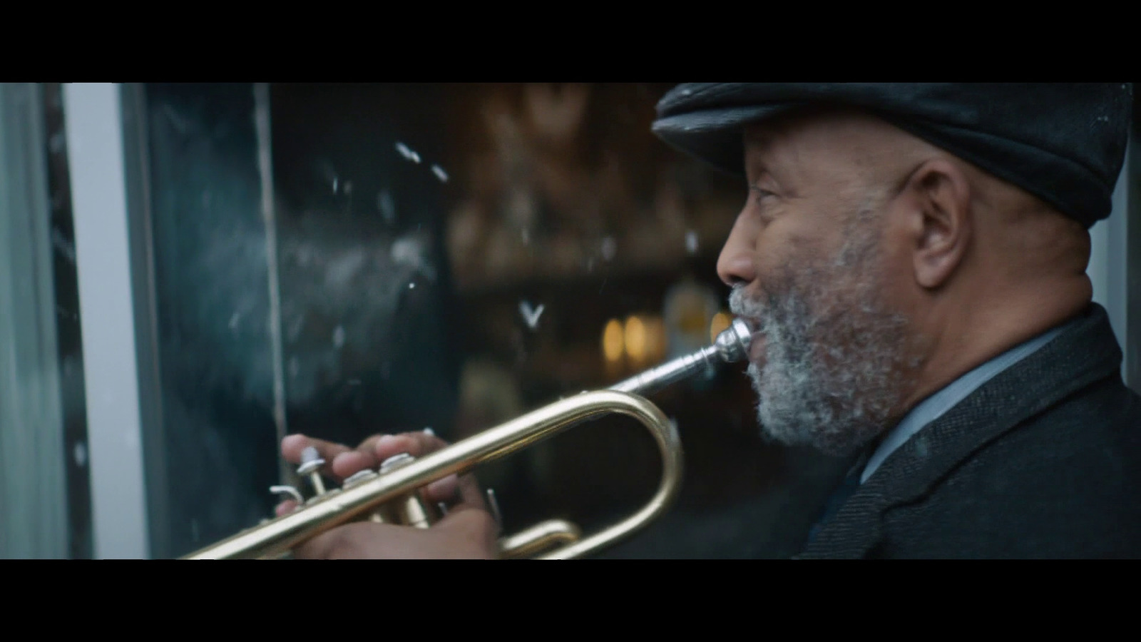 a man with a beard playing a trumpet