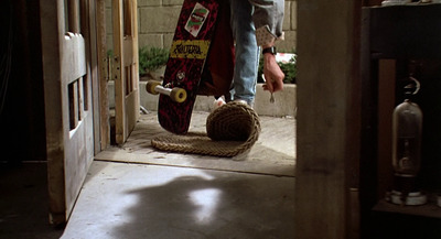 a person holding a skateboard in a doorway