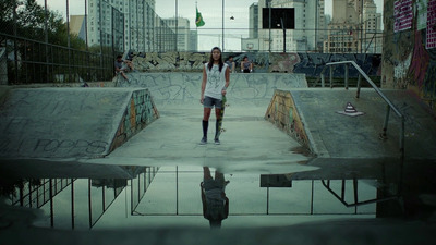 a skateboarder is standing in a skate park