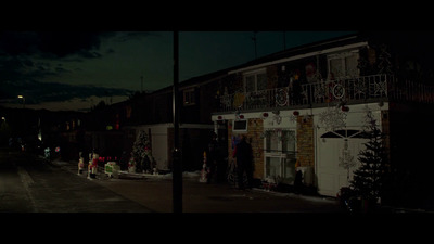 a street at night with a building decorated for christmas