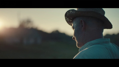 a man wearing a hat looking at the sun