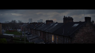 a row of houses with a cloudy sky in the background