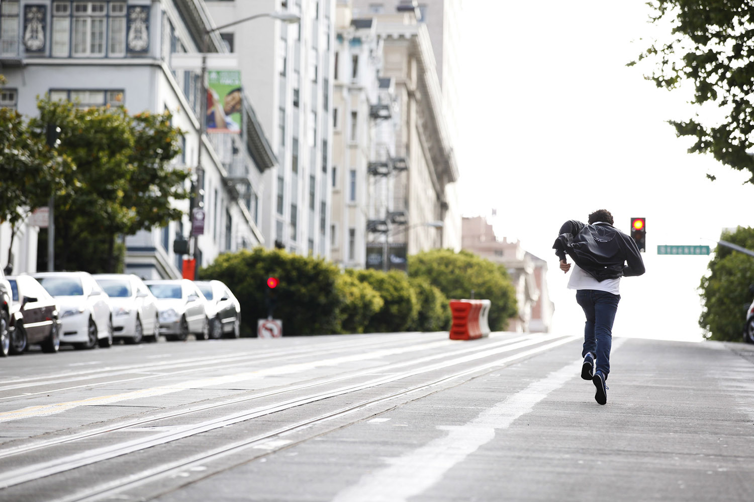 a man is running down the street with a backpack