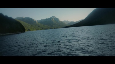 a body of water with mountains in the background