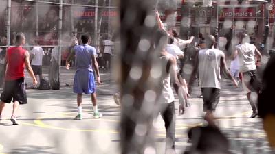 a group of young men playing a game of basketball