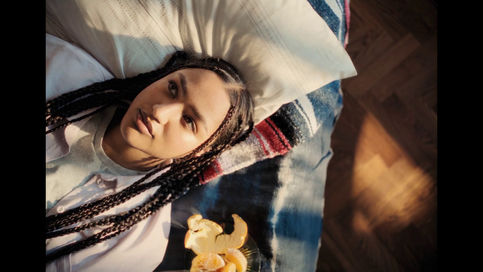 a woman laying on top of a bed next to a banana