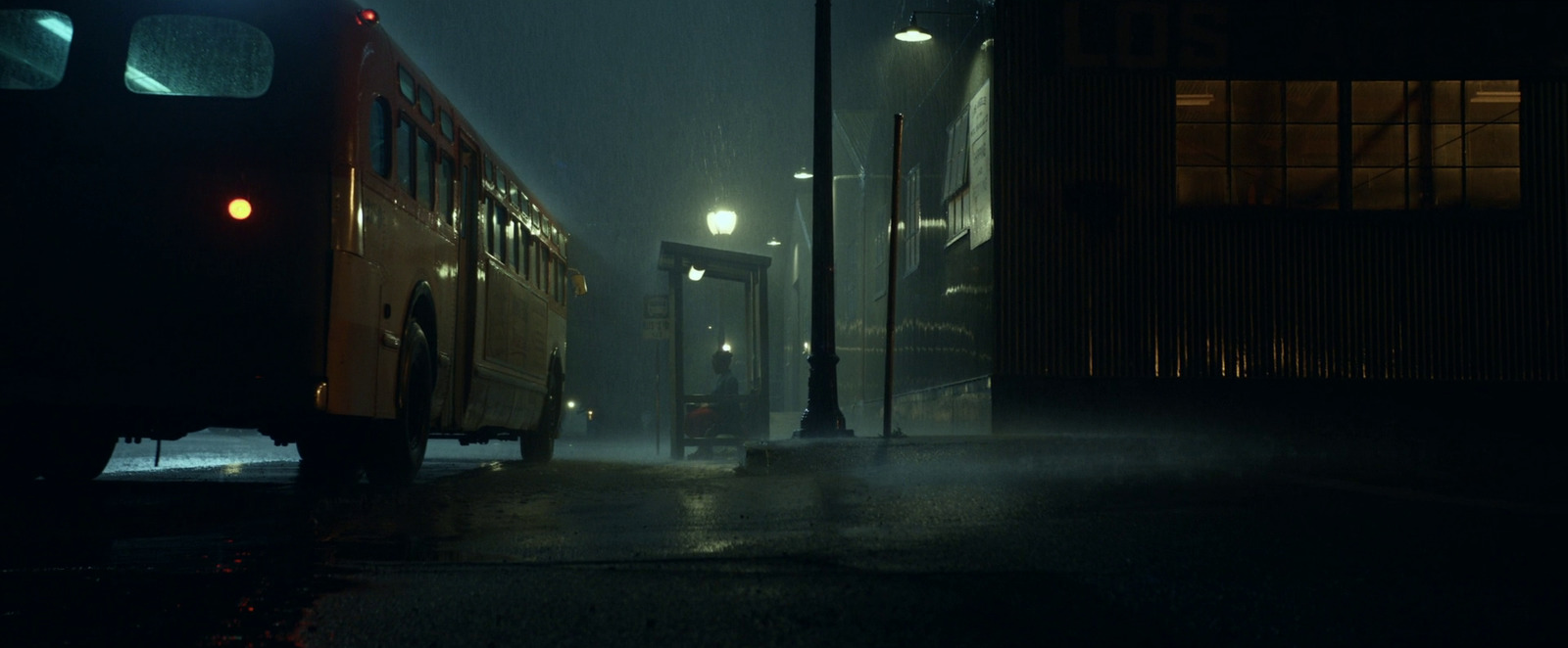 a bus driving down a street at night