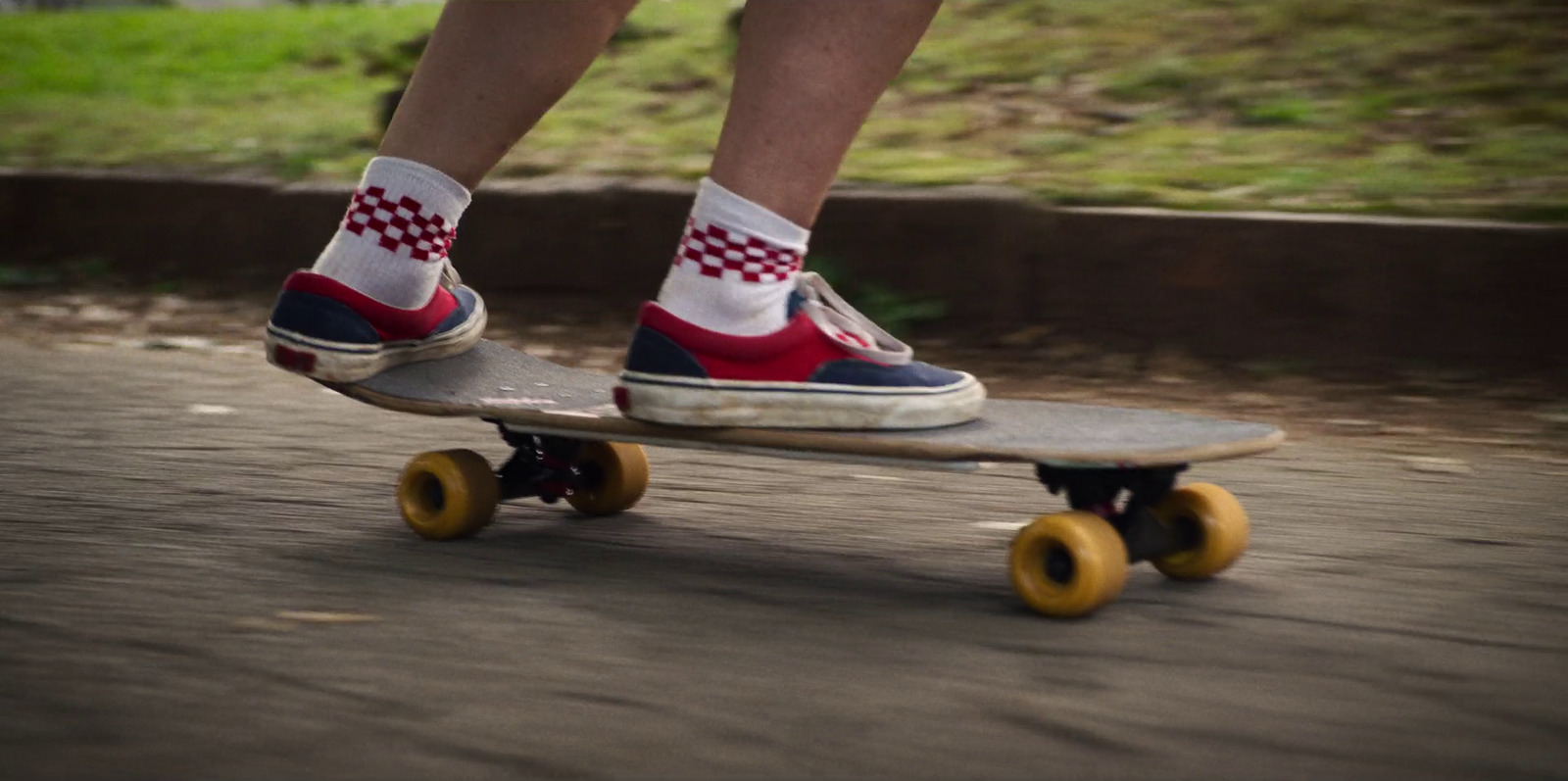 a person riding a skateboard down a street