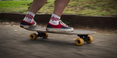 a person riding a skateboard down a street