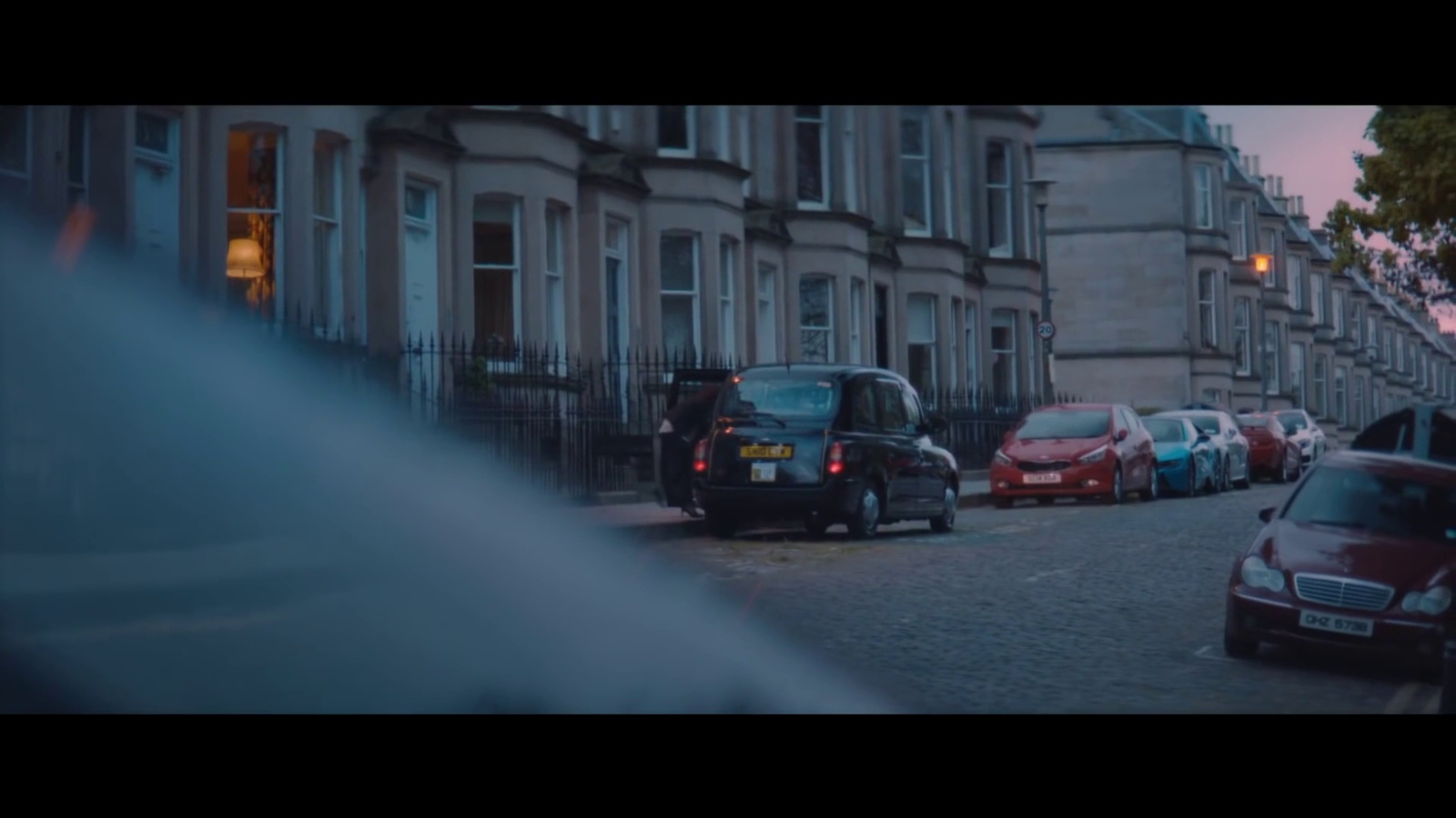 a row of parked cars on a city street