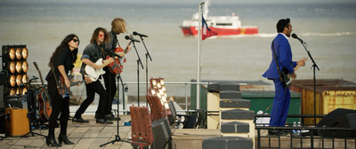 a group of people standing on top of a pier