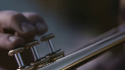 a close up of a person playing a trumpet