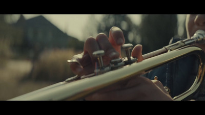 a close up of a person playing a trumpet