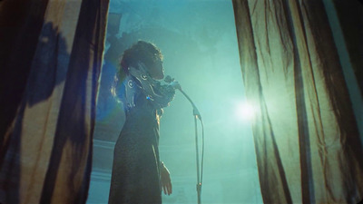 a woman standing in front of a microphone