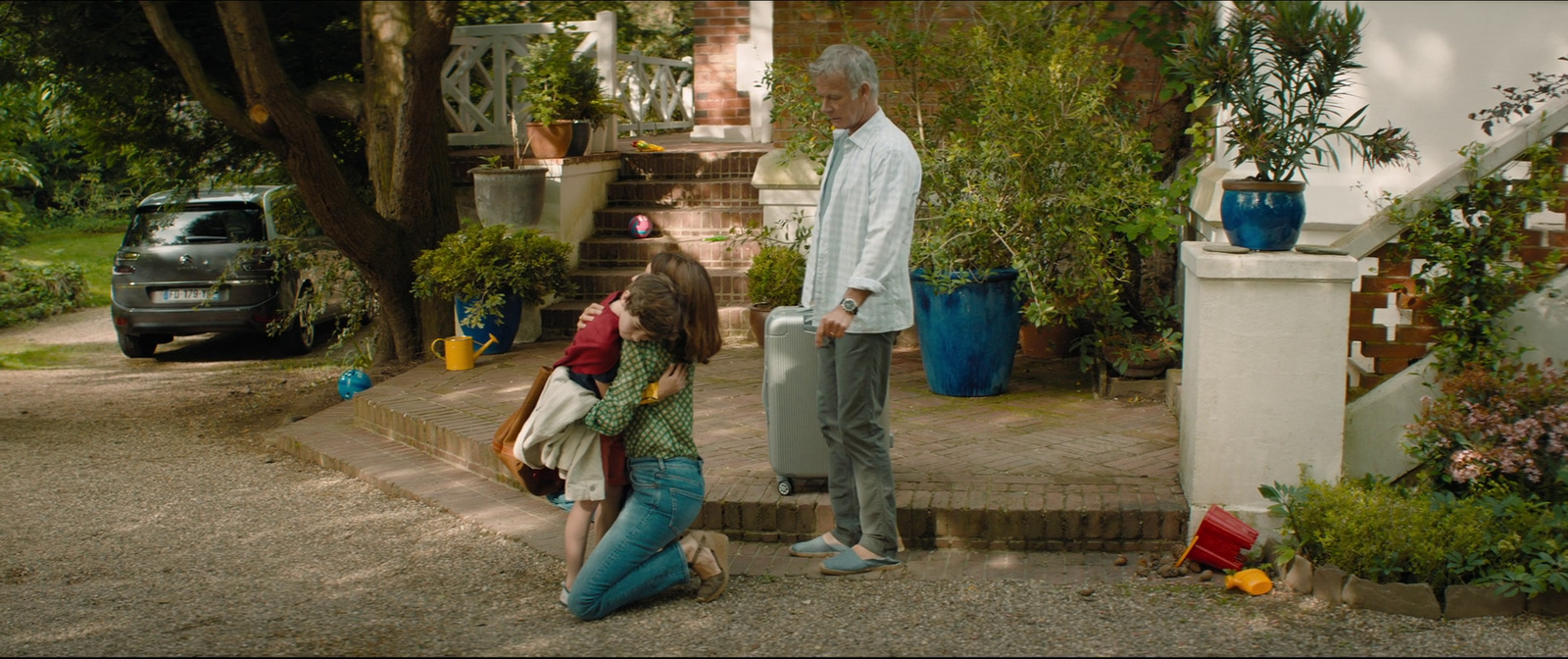 a man standing next to a woman in a driveway