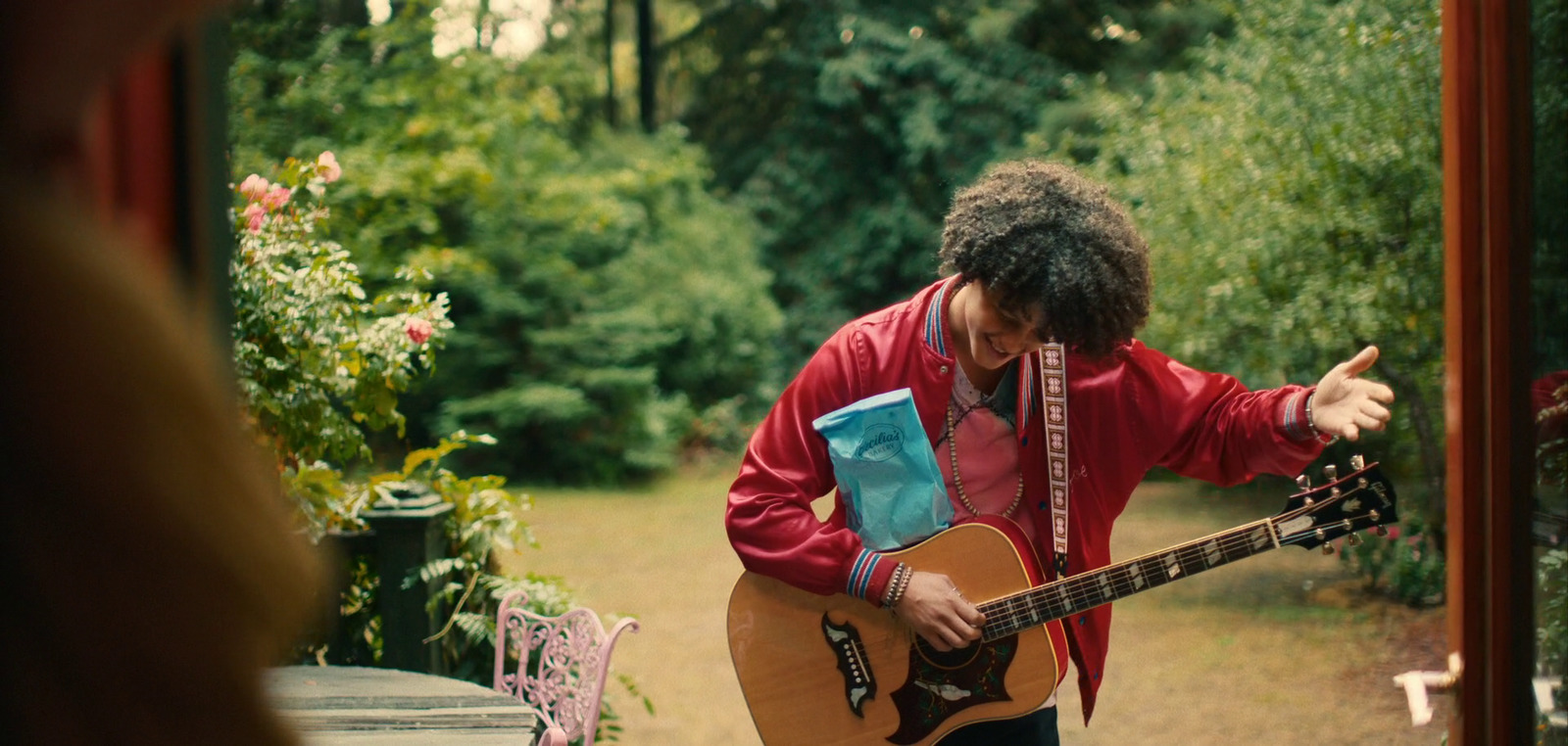 a man holding a guitar in his right hand