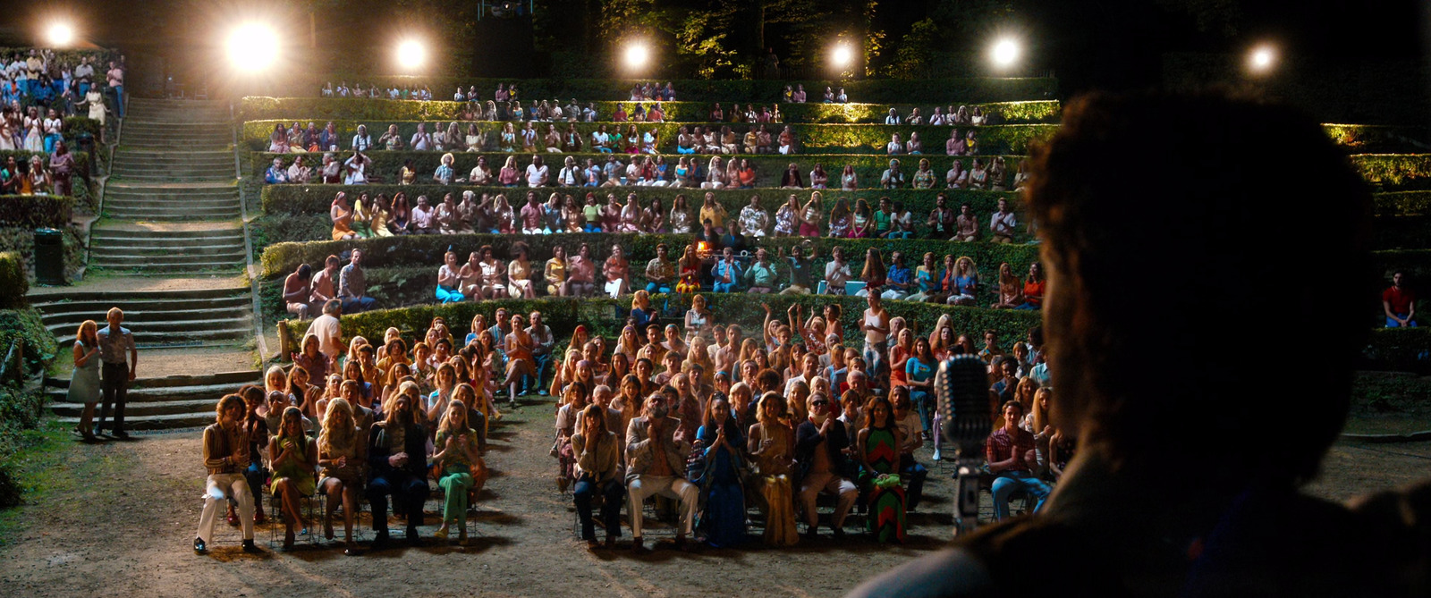 a group of people standing in front of a crowd of people