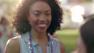 a woman smiles as she talks to another woman