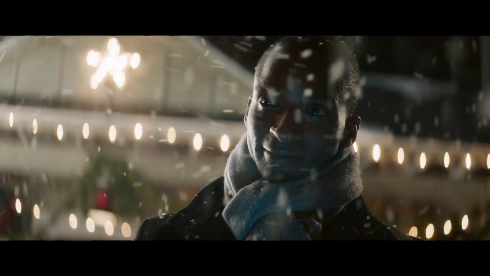 a man standing in front of a window covered in snow