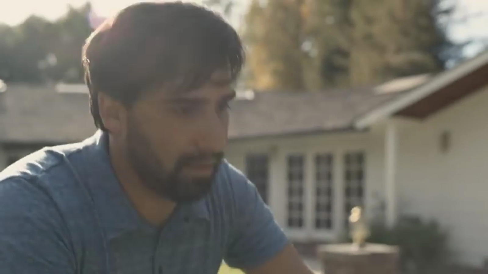 a man riding a skateboard in front of a house