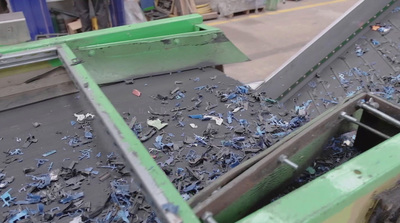 a dumpster filled with blue shredded paper