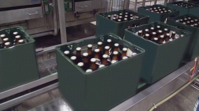 a conveyor belt filled with bottles of beer