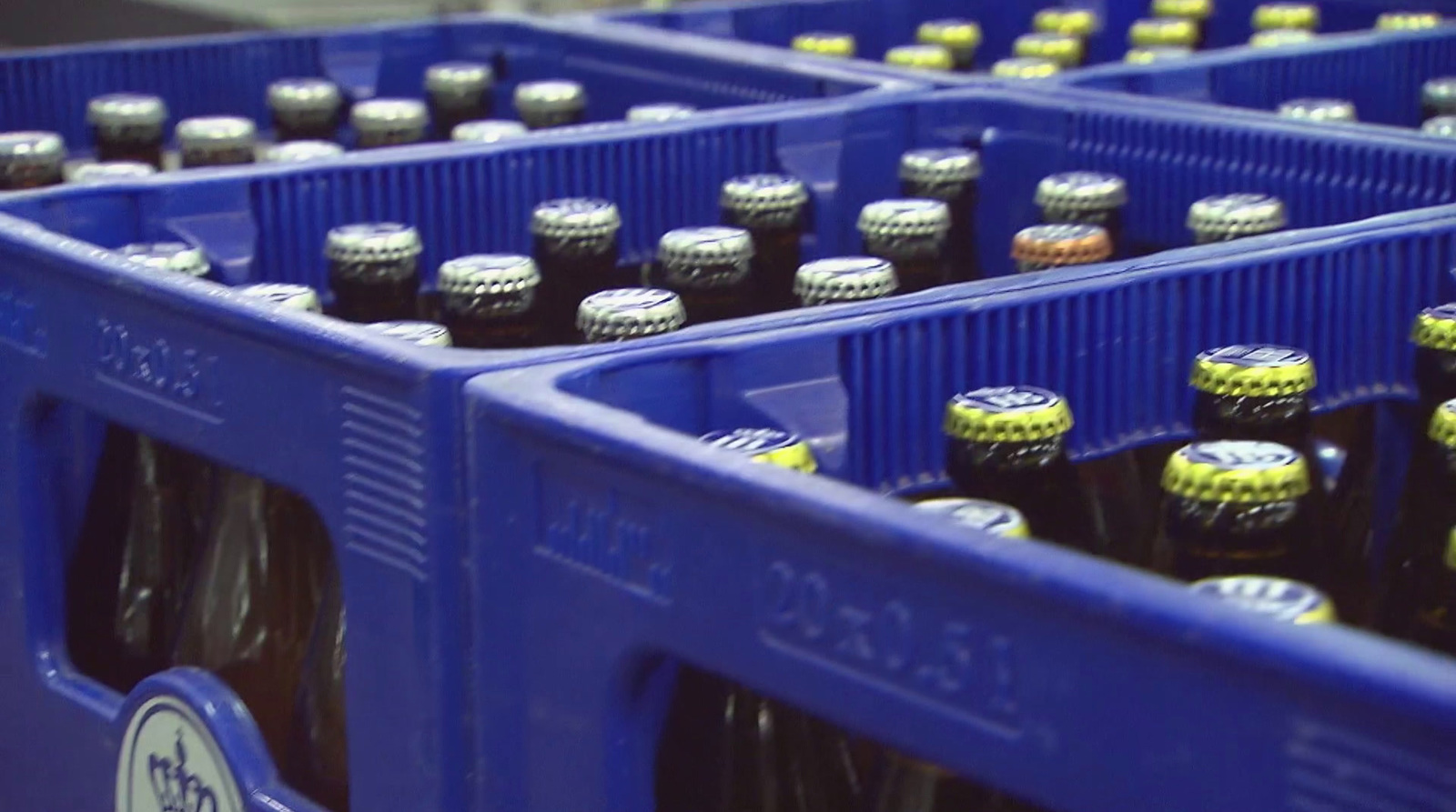 a bunch of bottles of beer sitting in a bin