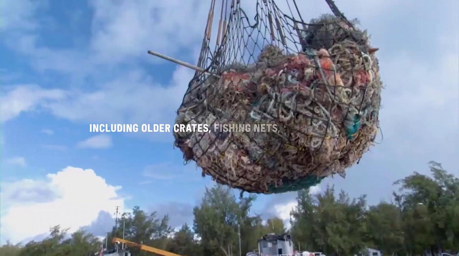 a large fishing net hanging from the side of a boat