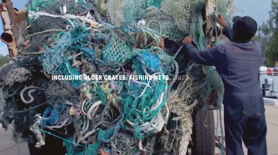 a man standing next to a truck full of fishing nets