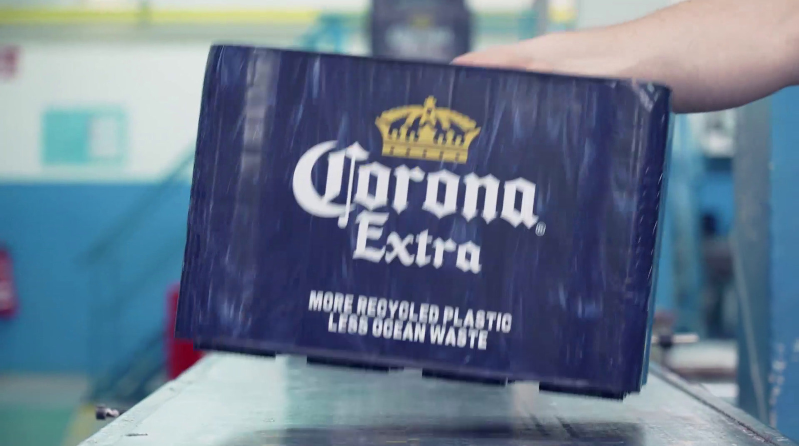 a box of corona extra on a conveyor belt