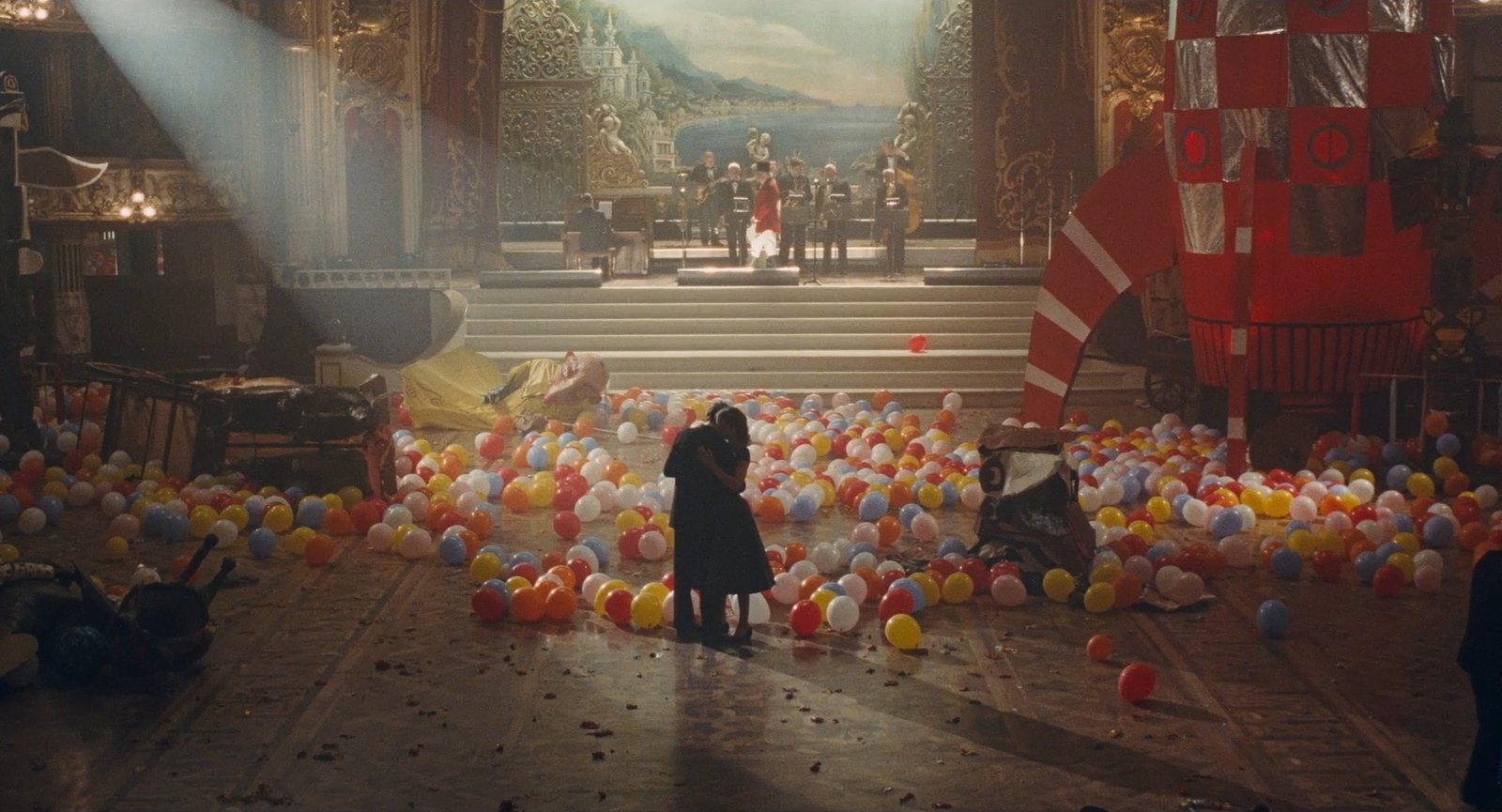 a person taking a picture of a stage with balloons