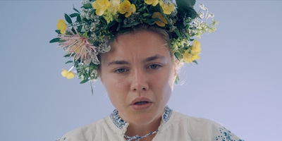 a woman with a wreath of flowers on her head