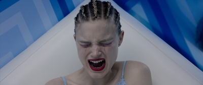 a woman in a bathtub with her mouth open