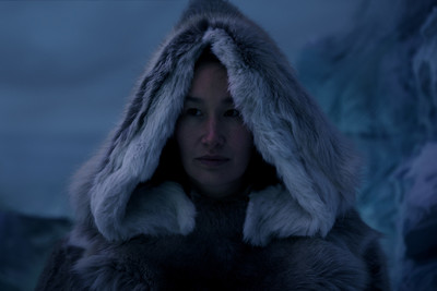 a woman in a fur coat with a hood on