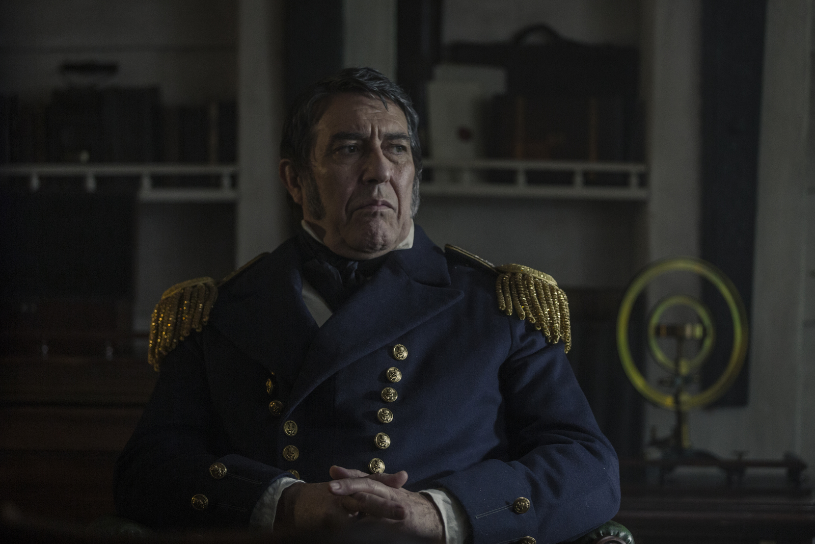 a man in uniform sitting in a room