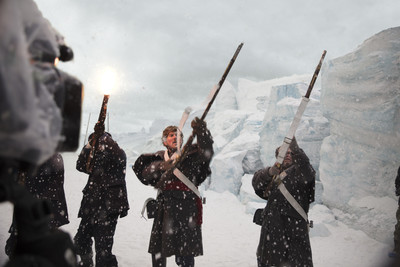 a group of people holding swords in the snow