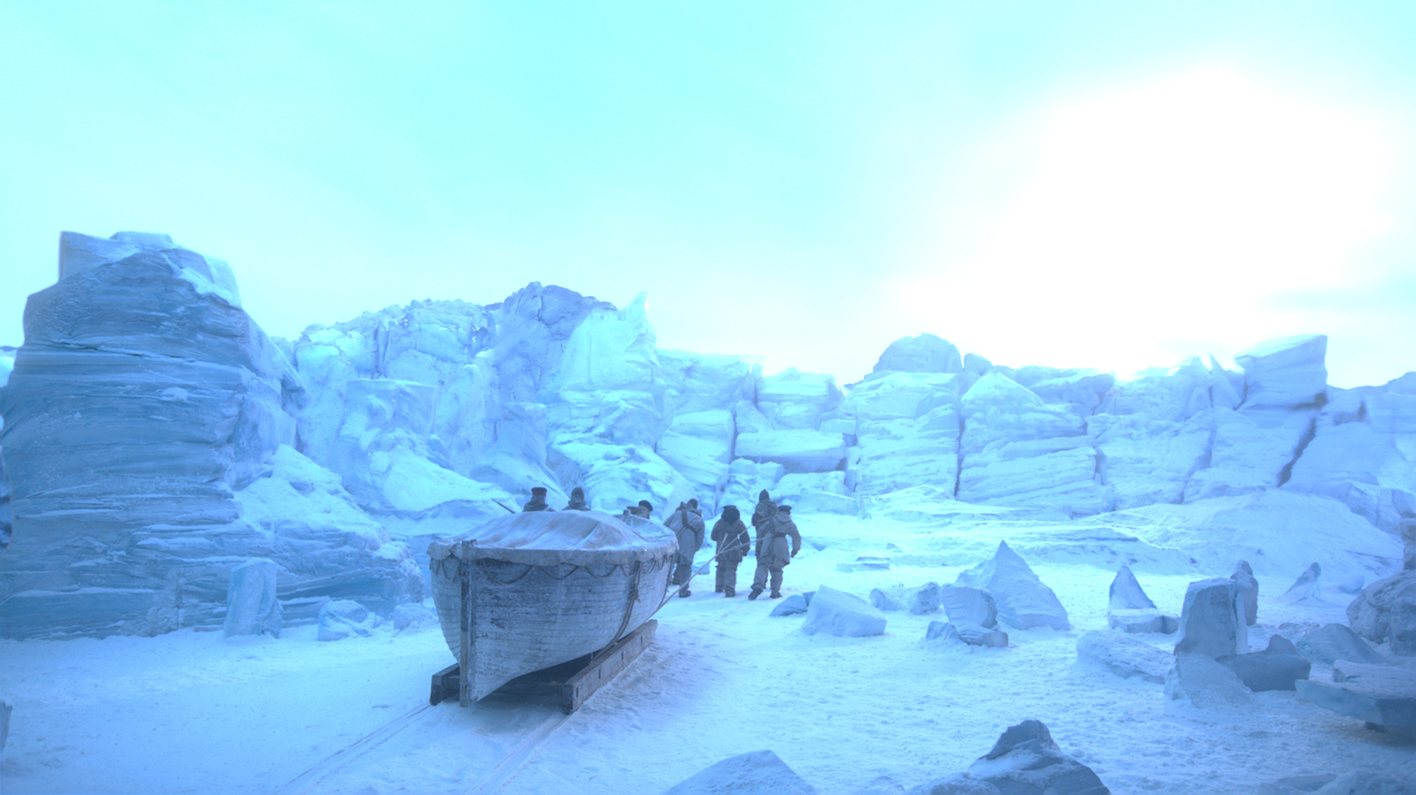 a group of people standing around a boat in the snow