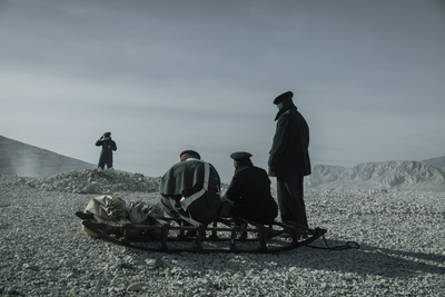 a group of people standing around a sled