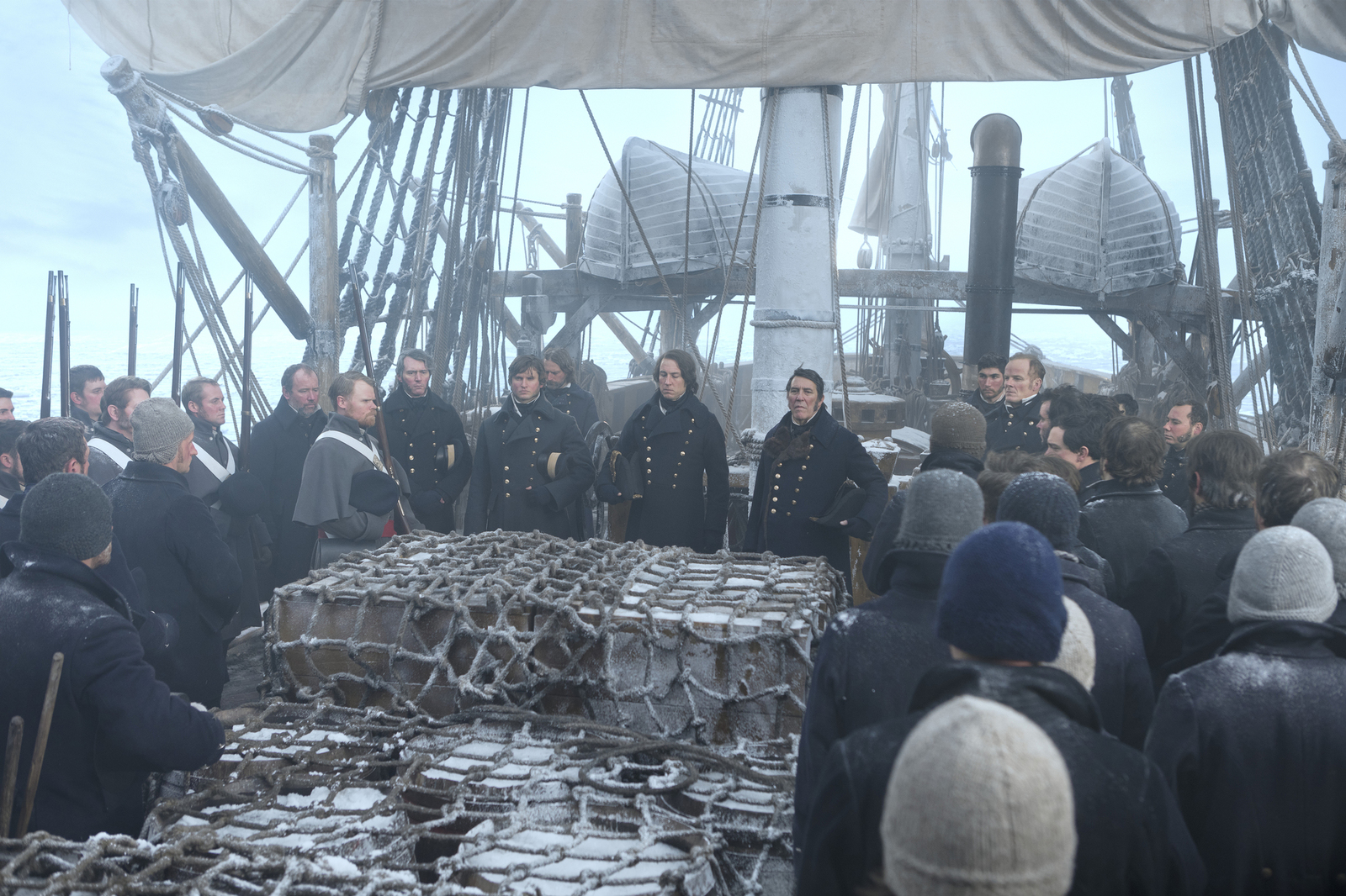 a group of people standing on top of a boat