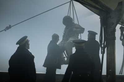 a group of men standing on top of a boat