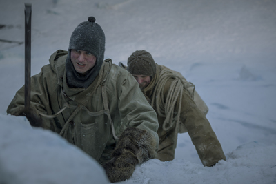 a couple of men in the snow next to each other