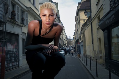 a woman is kneeling down on a city street