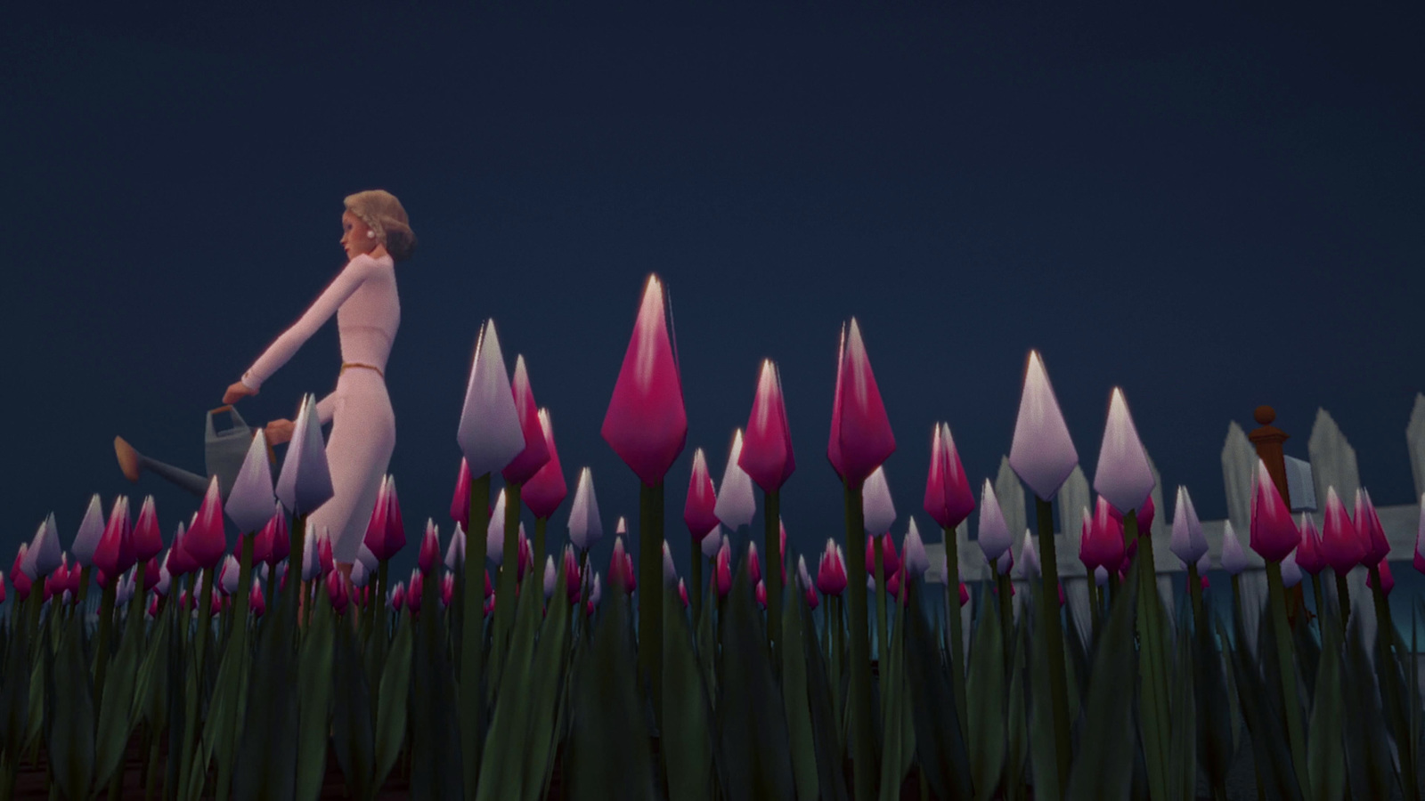 a woman walking through a field of pink tulips