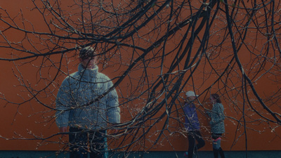 a couple of people standing next to a tree