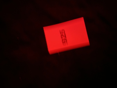 a close up of a red object in the dark