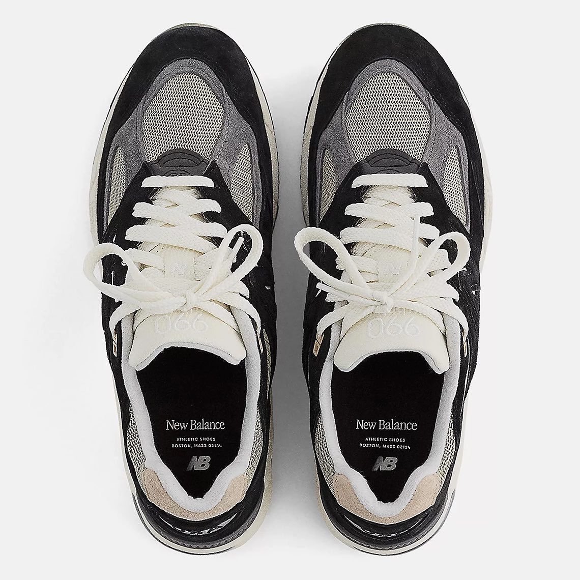 a pair of black and white sneakers on a white background